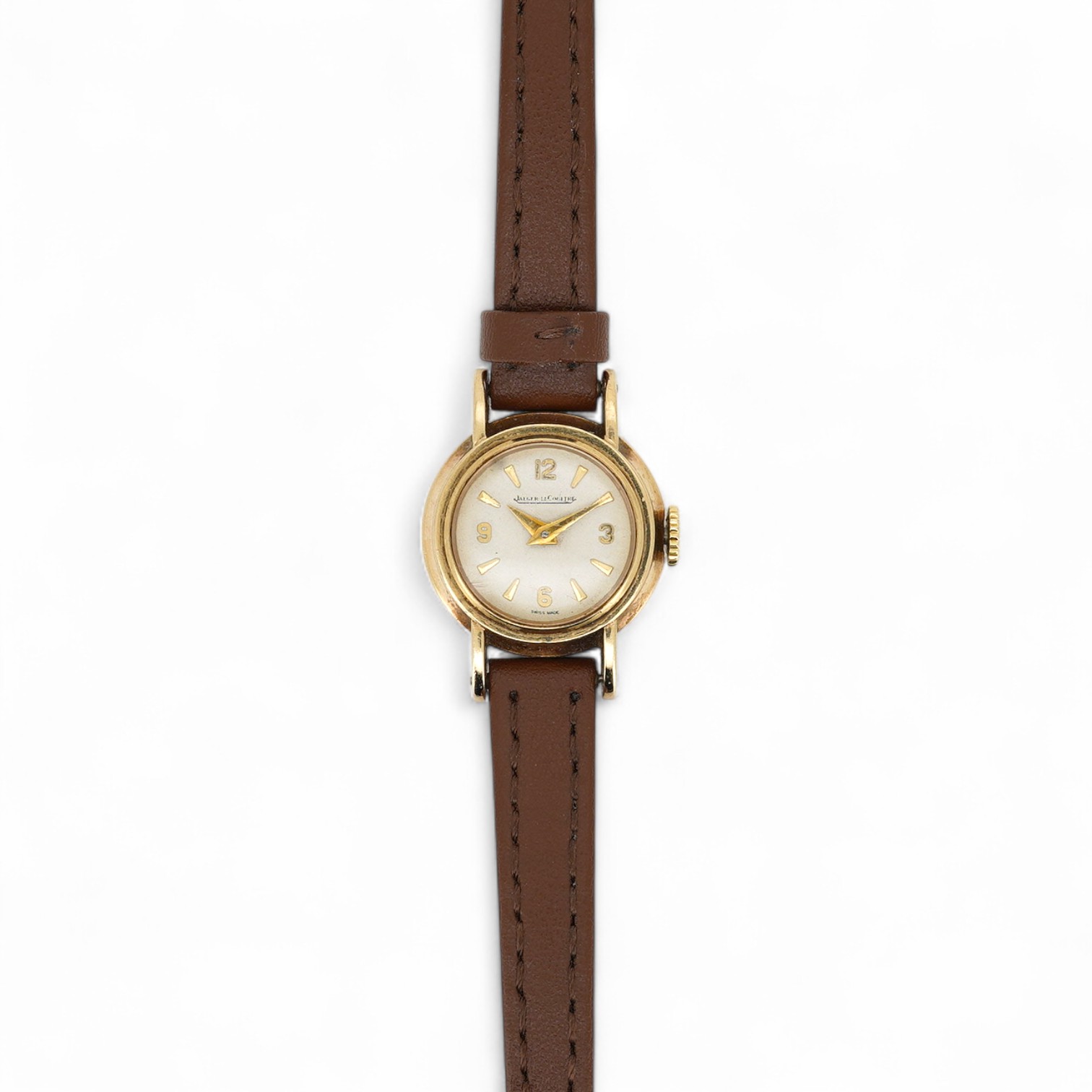 A lady's 9ct gold Jaeger LeCoultre manual wind wrist watch, with baton and quarterly Arabic numerals, cased diameter 20mm, on an associated leather strap, no box or papers.
